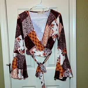 Long sleeve cropped blouse from Altar’d State. Size large. Patchwork pattern.